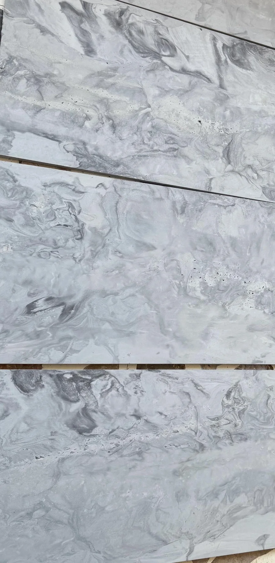 Close view of grey Rumett panels showing the flowing pattern left by the cast