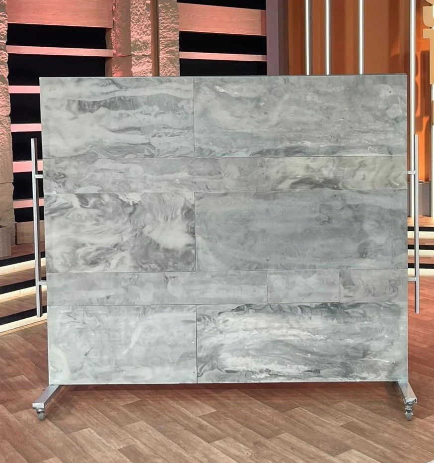 A freestanding Rumett wall on a wheeled frame, used as a room divider
