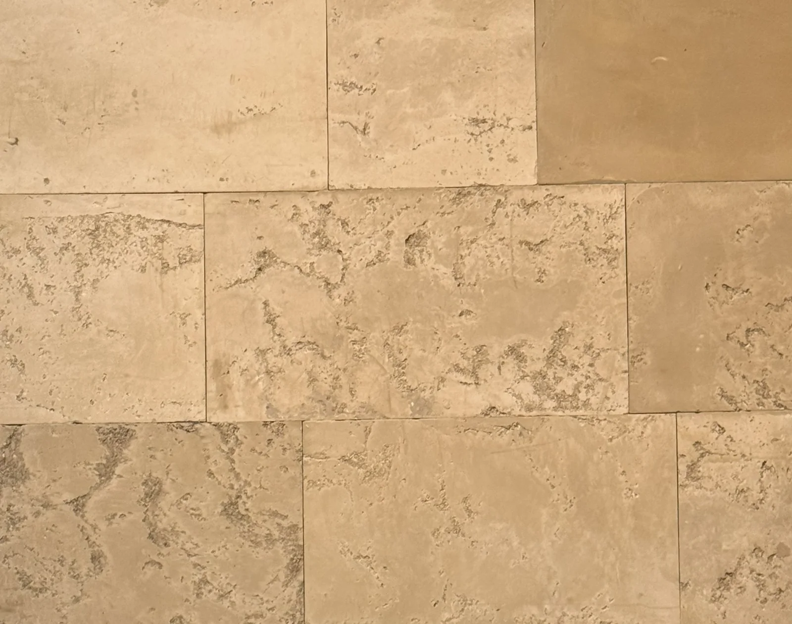 Monteret væg af Rumett paneler i en varm sandtone, hvor den støbte struktur varierer fra panel til panel